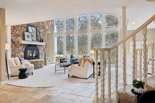 living room with a textured ceiling, a healthy amount of sunlight, and a fireplace