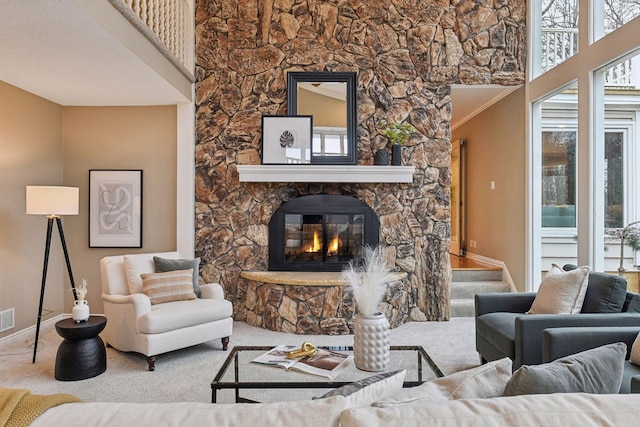 carpeted living room featuring a fireplace and ornamental molding