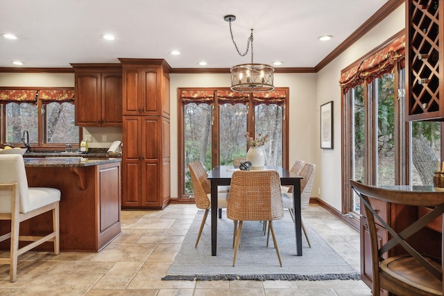 dining space featuring ornamental molding and a notable chandelier