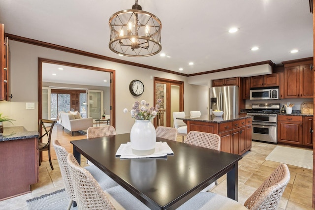 dining room with crown molding and a chandelier