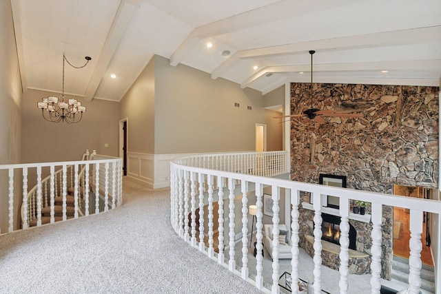 corridor featuring lofted ceiling with beams, carpet floors, and a chandelier