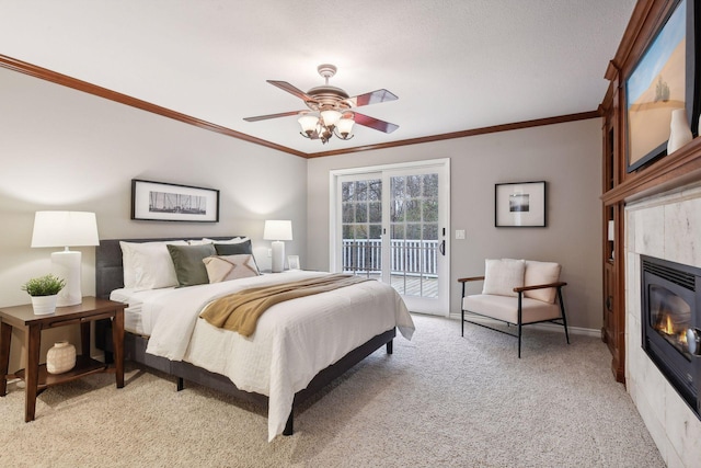 bedroom featuring a tile fireplace, ceiling fan, light colored carpet, access to outside, and ornamental molding