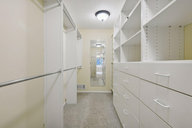 walk in closet featuring light colored carpet