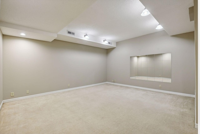 carpeted empty room with a textured ceiling