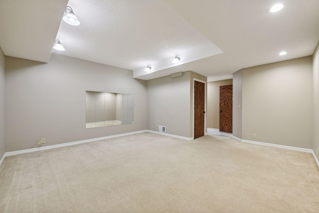 basement featuring carpet and a textured ceiling