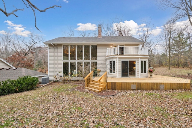 rear view of house with a balcony, central AC unit, and a deck