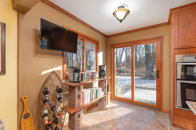 doorway to outside featuring crown molding