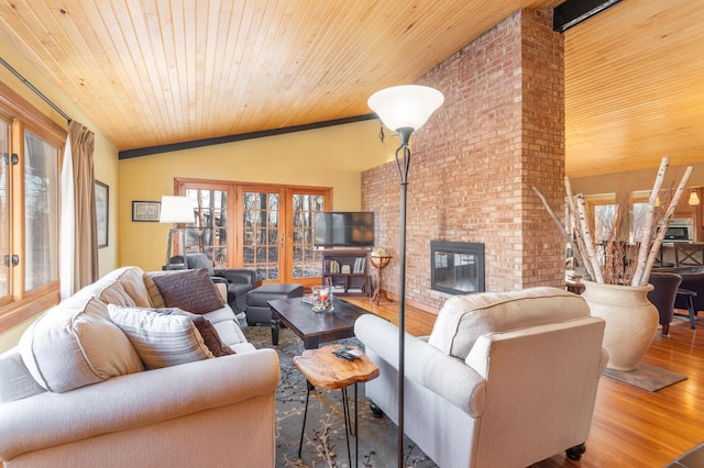 living room with a fireplace, wood-type flooring, vaulted ceiling, and wooden ceiling