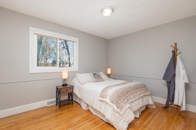 bedroom with hardwood / wood-style floors