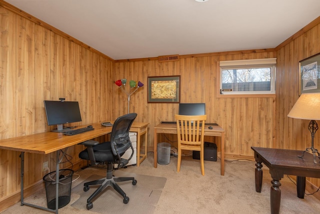 carpeted home office featuring wooden walls