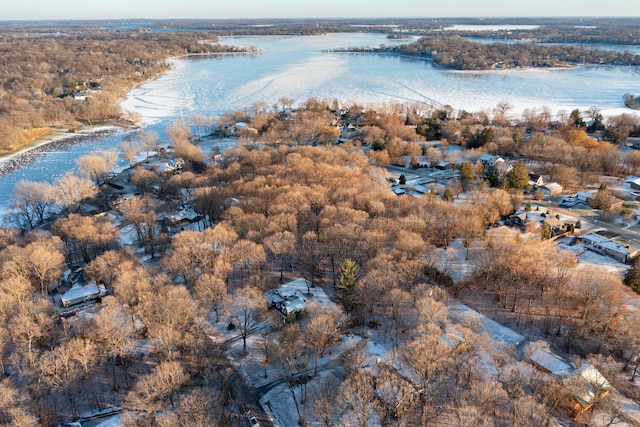 drone / aerial view featuring a water view and a wooded view