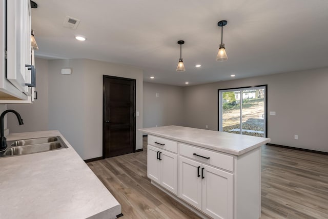 kitchen featuring visible vents, light wood-style flooring, recessed lighting, a sink, and light countertops