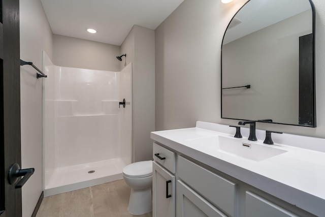 bathroom featuring toilet, vanity, walk in shower, and wood finished floors