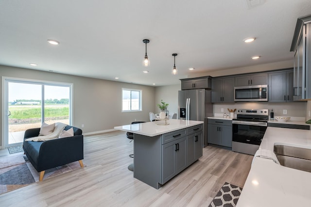 3104 Scotch Ln, Mankato, MN 56001 - kitchen with stainless steel appliances, open floor plan, recessed lighting, a breakfast bar, and gray cabinetry