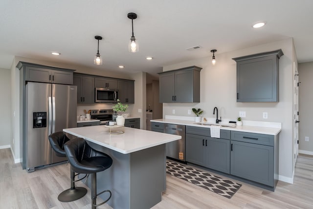 3104 Scotch Ln, Mankato, MN 56001 - kitchen featuring appliances with stainless steel finishes, light wood finished floors, a sink, light countertops, and recessed lighting