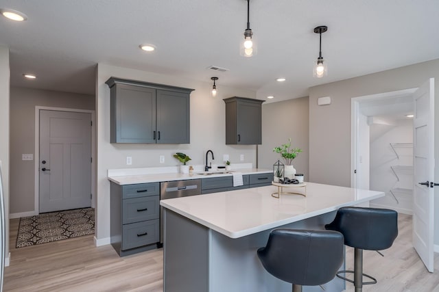 3104 Scotch Ln, Mankato, MN 56001 - kitchen with a sink, gray cabinetry, light countertops, pendant lighting, and light wood finished floors
