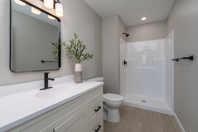 3104 Scotch Ln, Mankato, MN 56001 - full bath with toilet, vanity, a shower, and wood finished floors