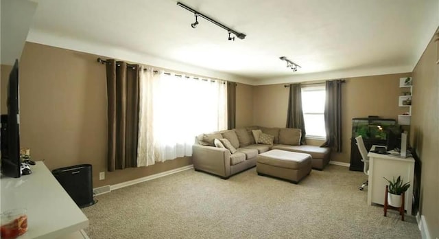 carpeted living room with track lighting