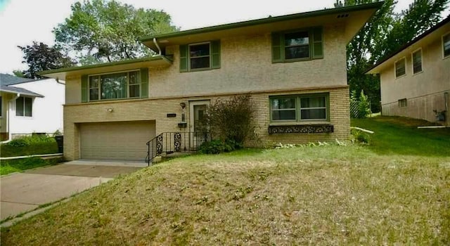 view of front of property with a front yard and a garage