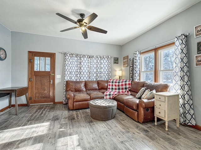 living room featuring hardwood / wood-style floors and ceiling fan