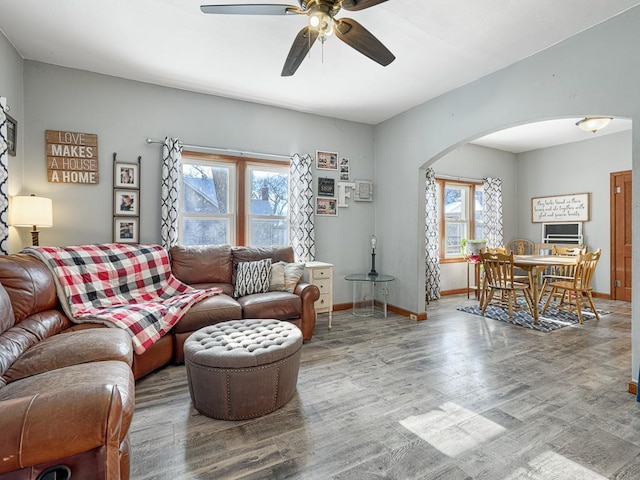 living room featuring hardwood / wood-style flooring, plenty of natural light, and ceiling fan