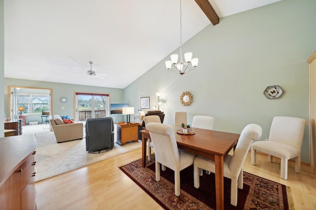 dining space featuring beam ceiling, ceiling fan with notable chandelier, light hardwood / wood-style floors, and high vaulted ceiling