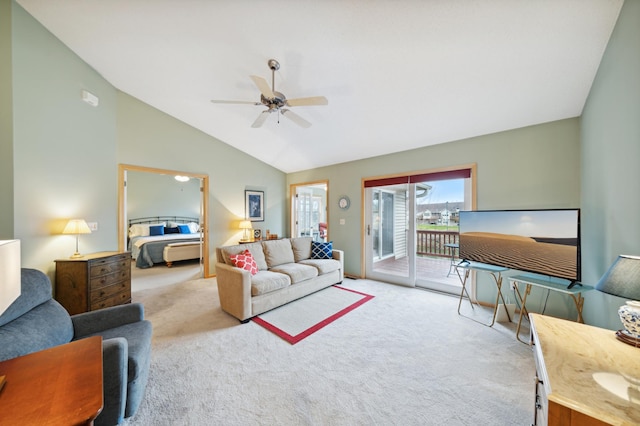 carpeted living room with ceiling fan and vaulted ceiling