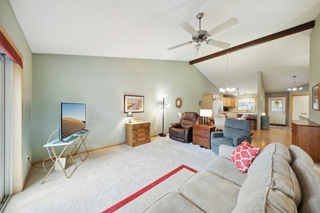 carpeted living room with ceiling fan with notable chandelier and lofted ceiling