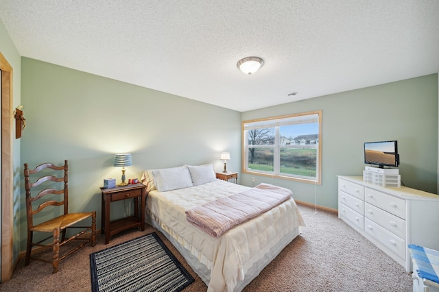 bedroom with a textured ceiling and carpet floors