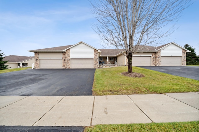 ranch-style house with a garage and a front lawn