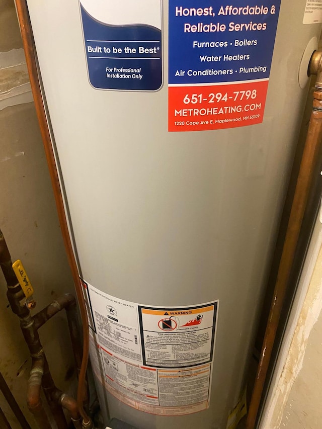 utility room featuring gas water heater