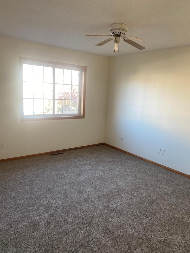 empty room with carpet and ceiling fan