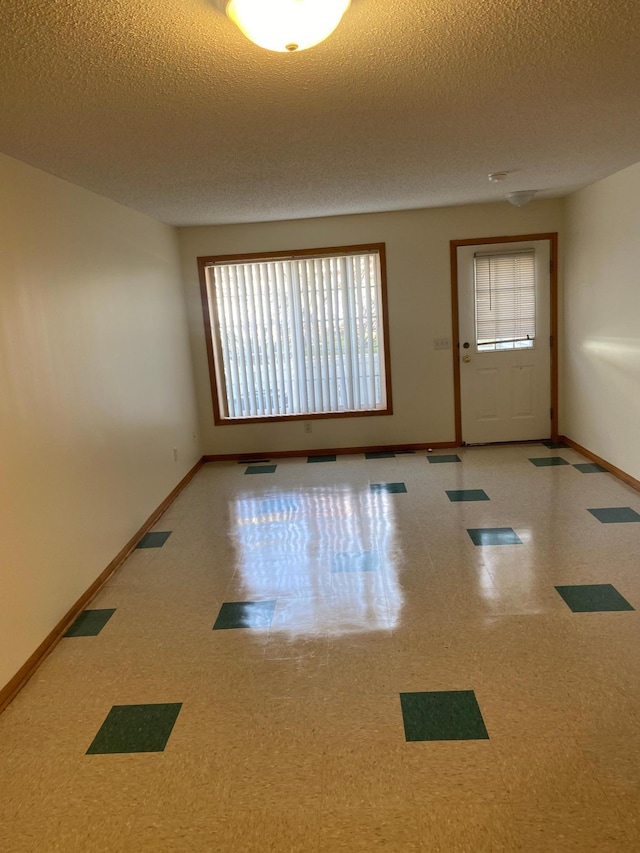 empty room featuring a textured ceiling