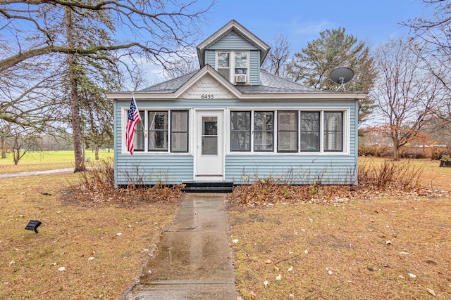 bungalow-style house with a sunroom