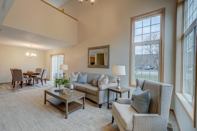 living room with a towering ceiling and an inviting chandelier