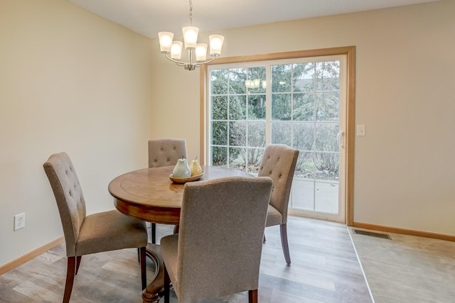 dining room featuring a chandelier and light hardwood / wood-style flooring