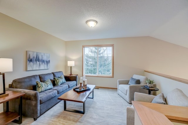 living room with light carpet, a textured ceiling, and vaulted ceiling