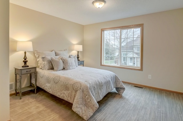 bedroom with light hardwood / wood-style flooring