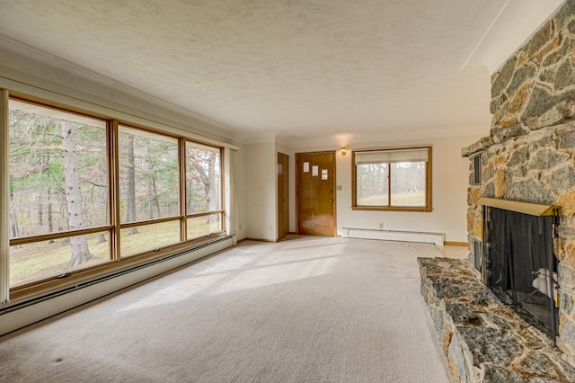 carpeted living room featuring a fireplace, baseboard heating, and plenty of natural light