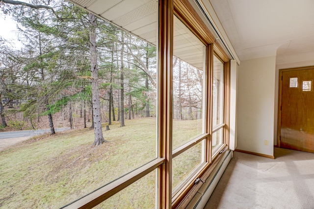 unfurnished sunroom with a baseboard heating unit