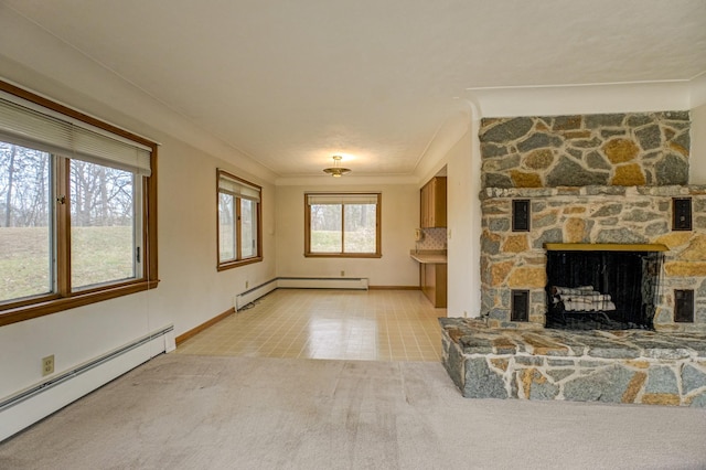 unfurnished living room with baseboard heating, light carpet, a fireplace, and ornamental molding