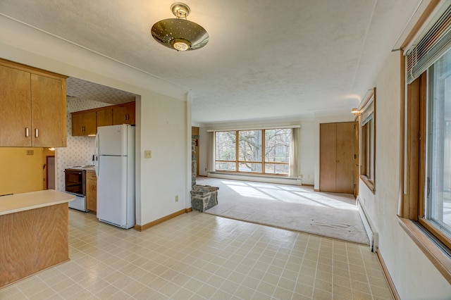 kitchen featuring a textured ceiling, electric range, a baseboard heating unit, and white refrigerator