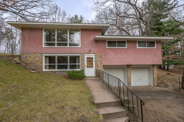 view of front of property with a front yard and a garage