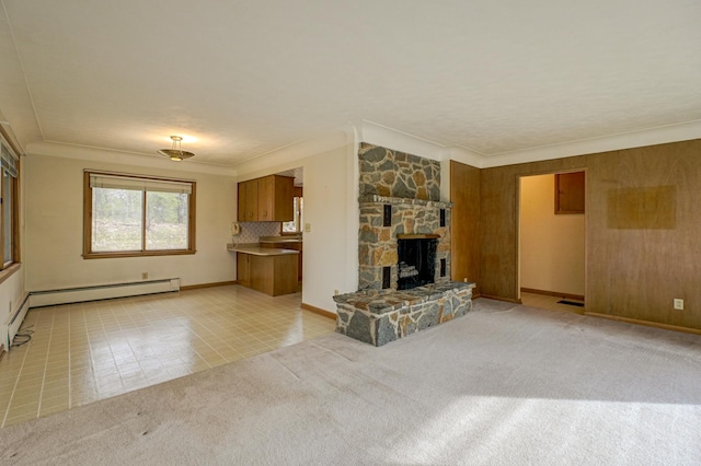 unfurnished living room with crown molding, a fireplace, light colored carpet, and a baseboard radiator