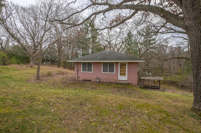 view of side of home featuring a yard