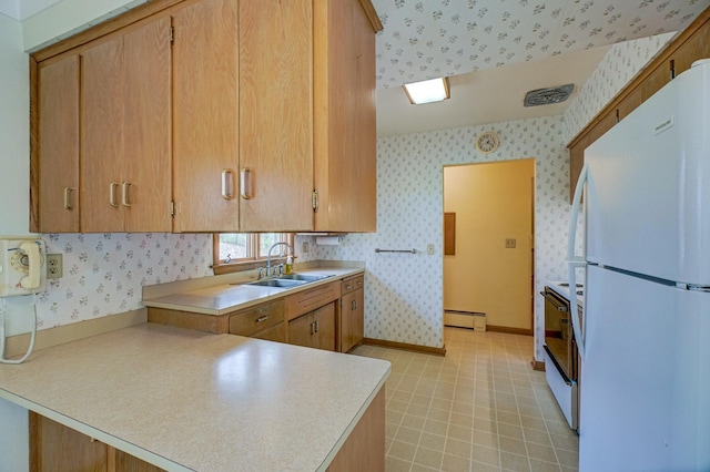 kitchen with kitchen peninsula, white appliances, sink, and a baseboard heating unit