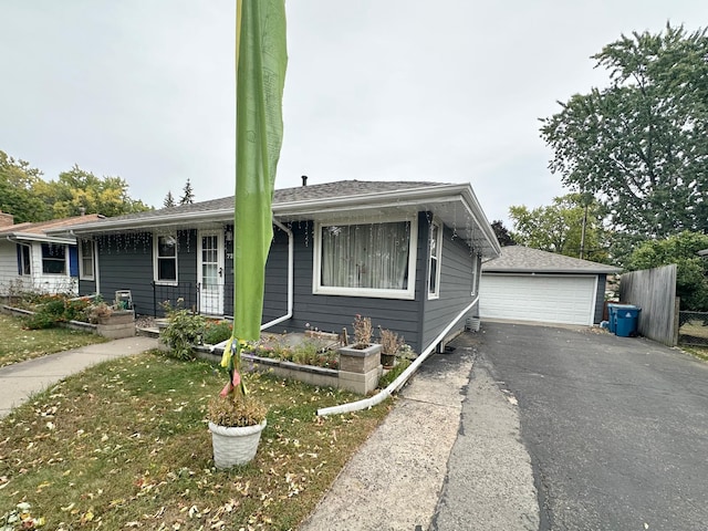 view of front facade featuring covered porch, a garage, and an outbuilding