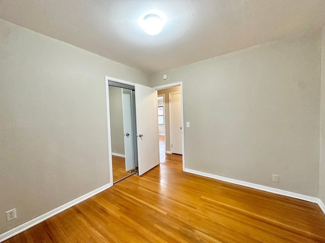 unfurnished room with hardwood / wood-style floors