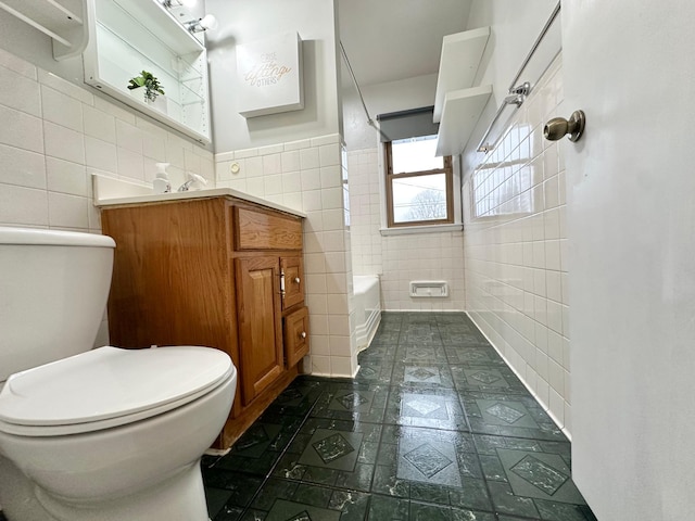 full bathroom featuring vanity, shower / bathtub combination, toilet, and tile walls