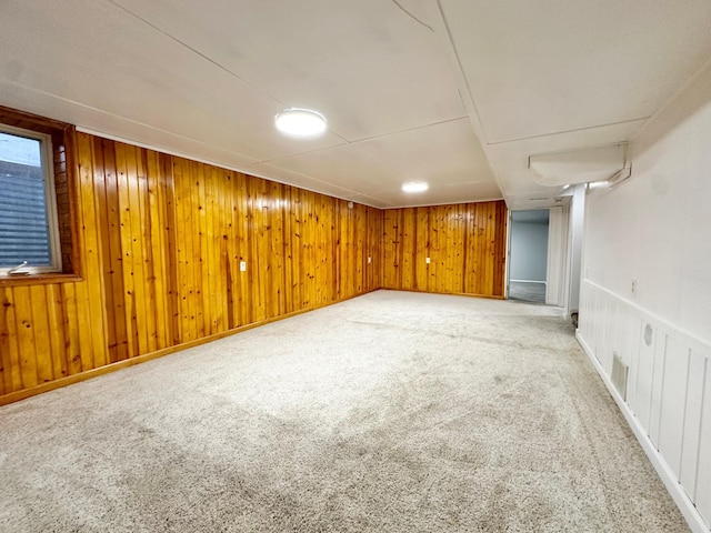 basement with wood walls and carpet floors